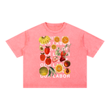 Fruits of Our Labor Tee in pink, off-white type over the botanical fruit collage on a washed coral-pink blank — On The Job Clothing