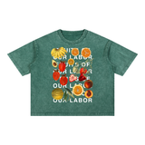 Fruits of Our Labor Tee in blackish green, the campaign name in six lines of off-white type layered over a botanical fruit collage across the chest — On The Job Clothing